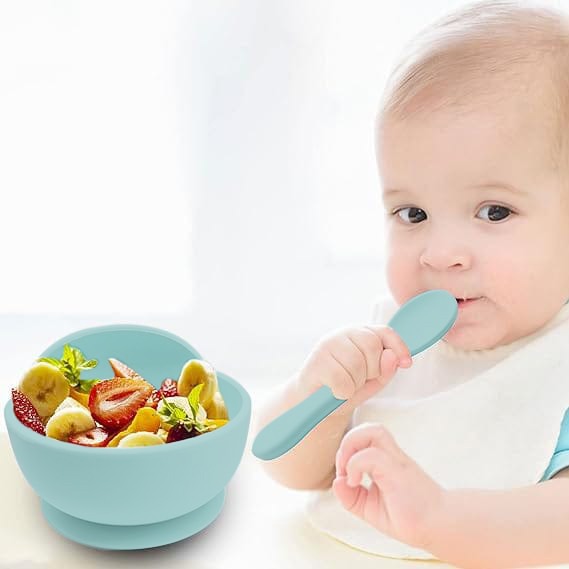 Baby is Eating Food In a Baby Silicone Feeding Bowl .