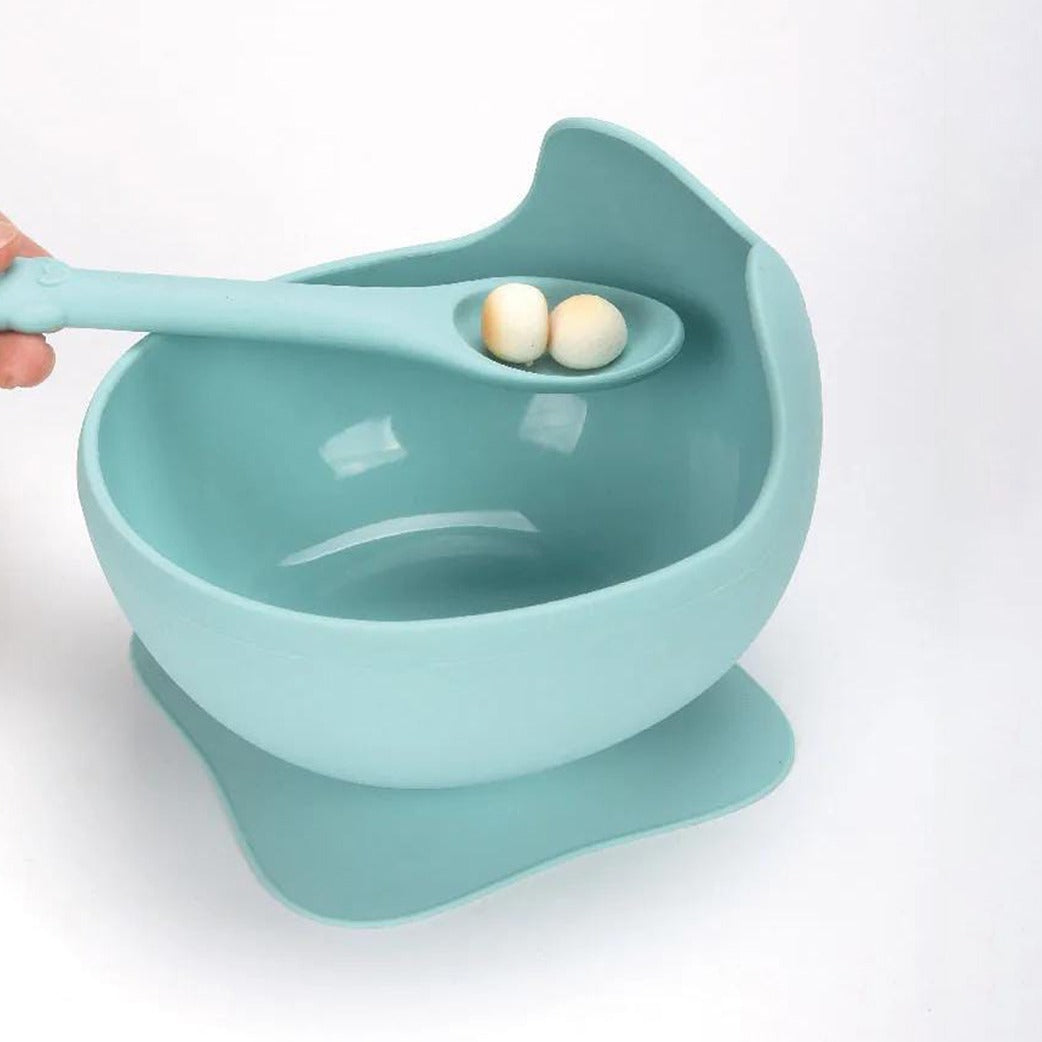 A Person is Holding Food in a Baby Silicone Feeding Bowl.