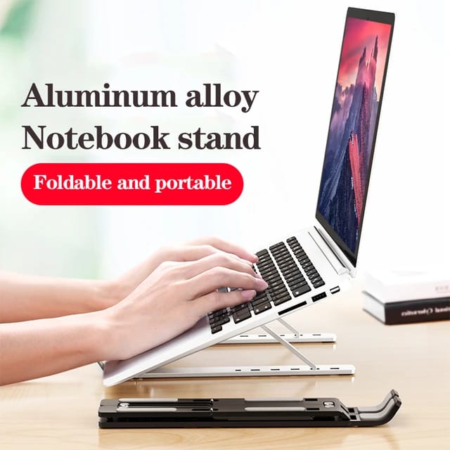 A Person is Working On Laptop By Placing it On Foldable Aluminum  Laptop Holder Rack.