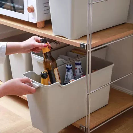 Someone is taking a bottle from the Space-Saving Narrow Gap Long Storage Box with Wheels