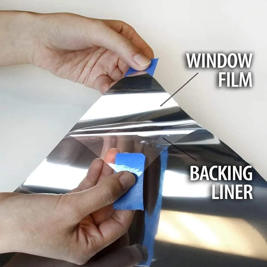 A Person is Removing the Sticker Of Window Privacy Film. 