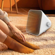 A Person is Sitting Infront Of Winning Star Portable Space Heater.