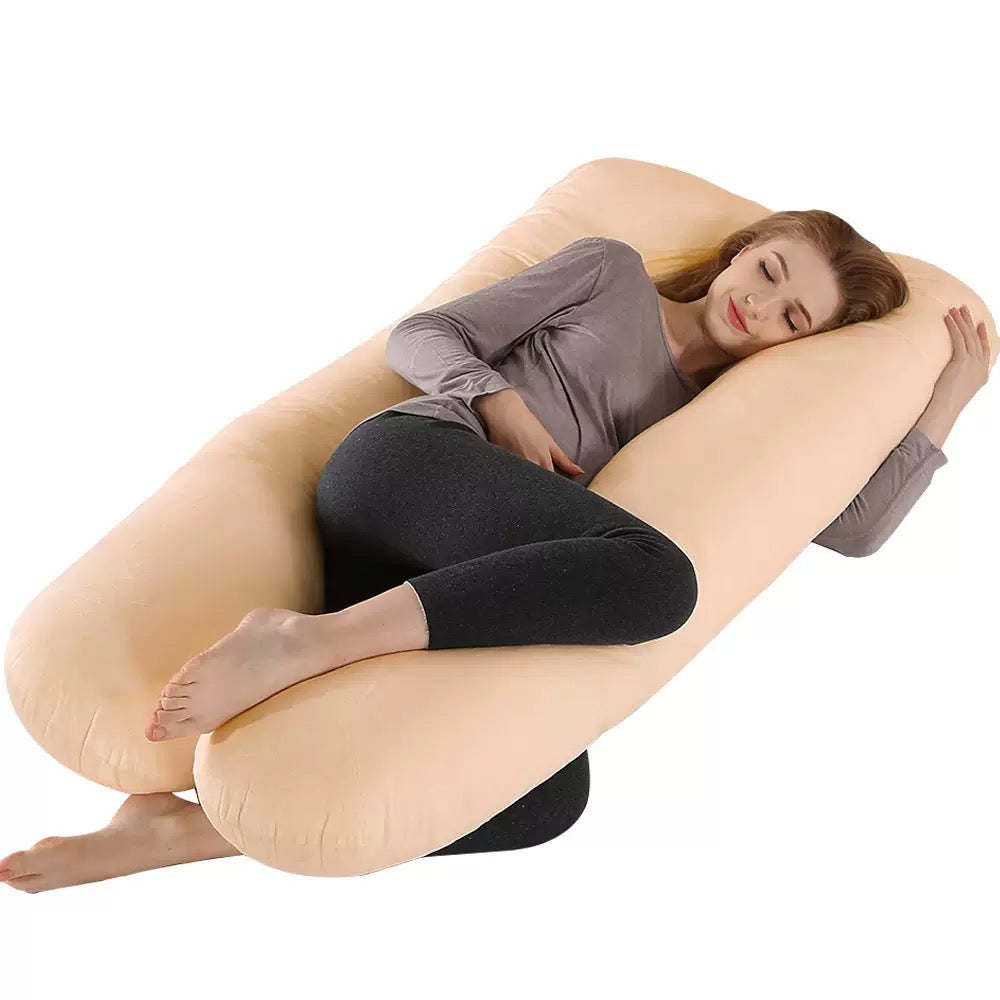 Woman relaxing with maternity pillow.