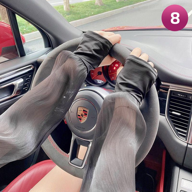 A Women is Wearing Women Summer Arm Sleeves While Driving.