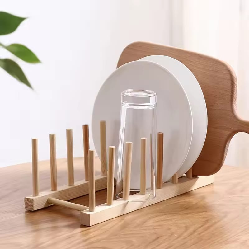 A Wooden Dish Holder is Holding Glass, Plates and Cutting Board.