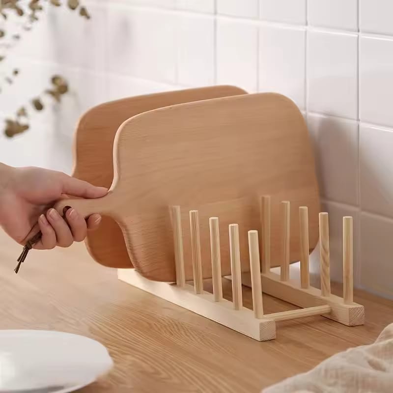 A Person is Taking Cutting Board From Wooden Dish Holder.