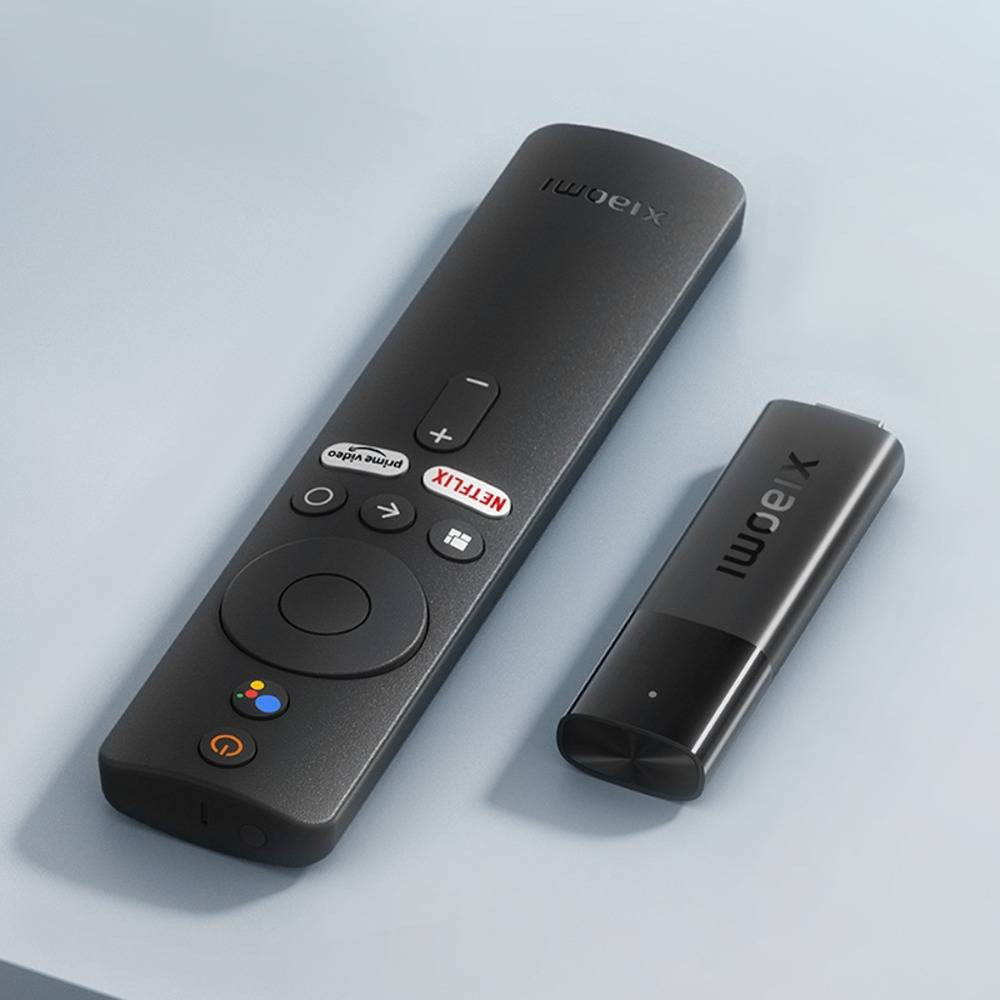 Xiaomi TV MDZ-27-AA Stick 4K placed on the table with Remote Control and Google Assistant