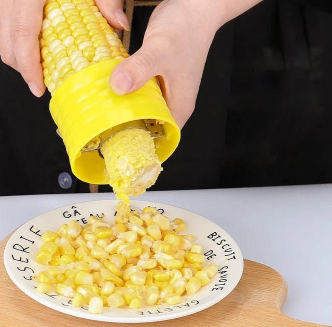 A Person is Peeling Corn Using Corn Stripper Peeler.