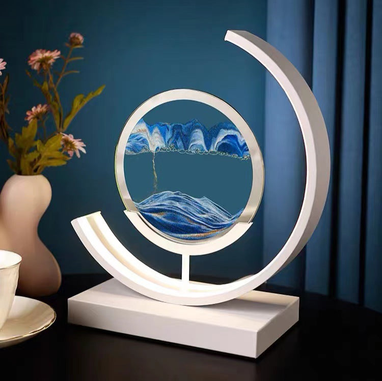 Quicksand 3D Table Lamp placed next to a flower vase and tea cup on a table 