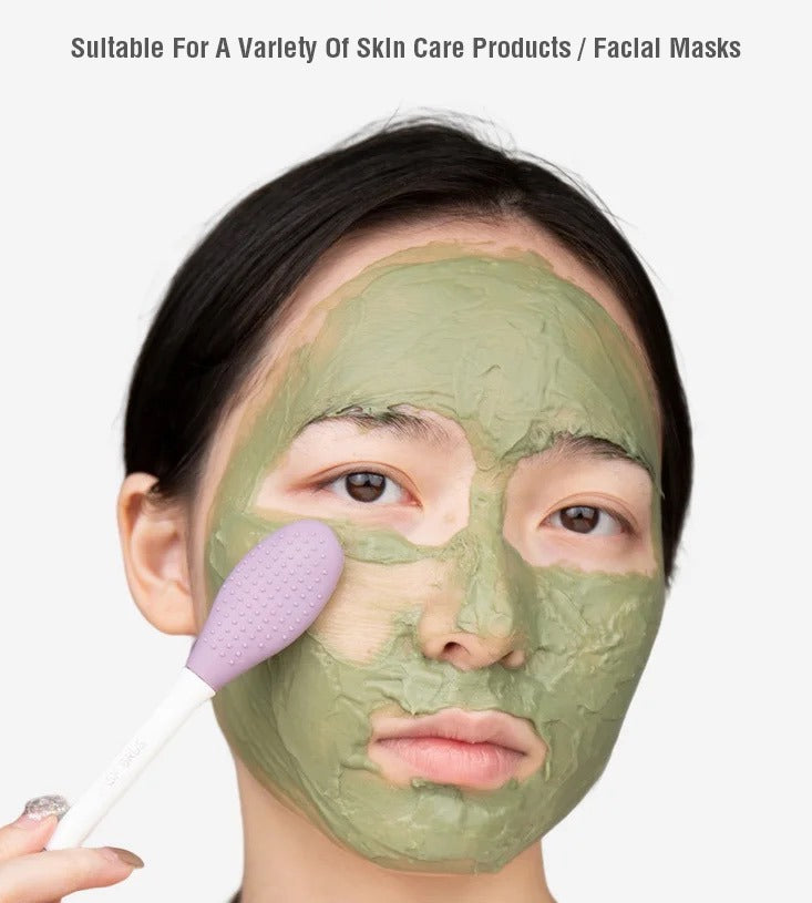  A woman applies a green facial mask with a Double-Head Facial Mask Brush