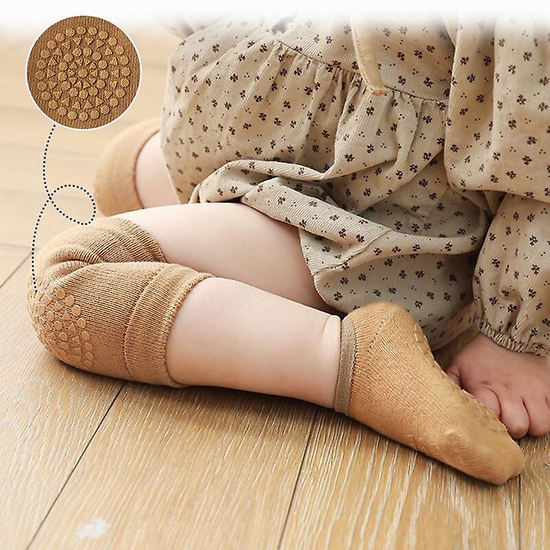 Baby's elbows protected with padded socks and knee pad.