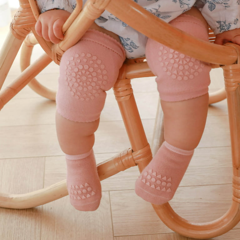 Happy Baby wearing pink knee and elbow socks.