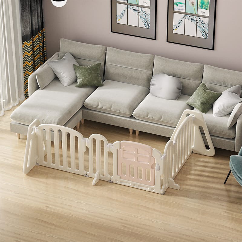 A baby playpen set up in a living room.