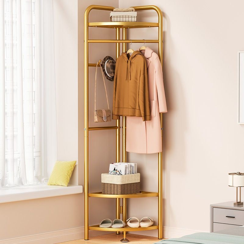 Golden color garment clothing rack where clothes, bag and hat is hanged.