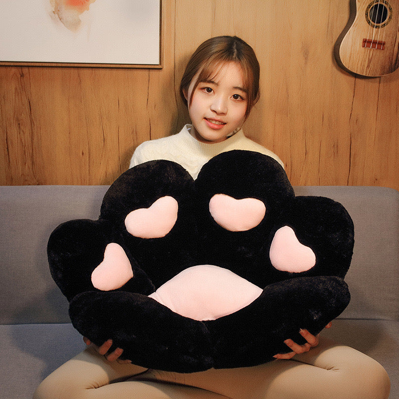 Women holding black cat paw cute cushion