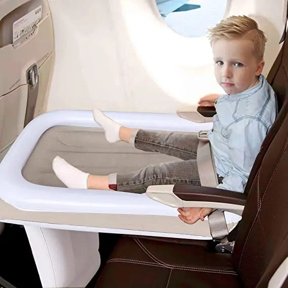 boy sitting on air bed in aeroplane