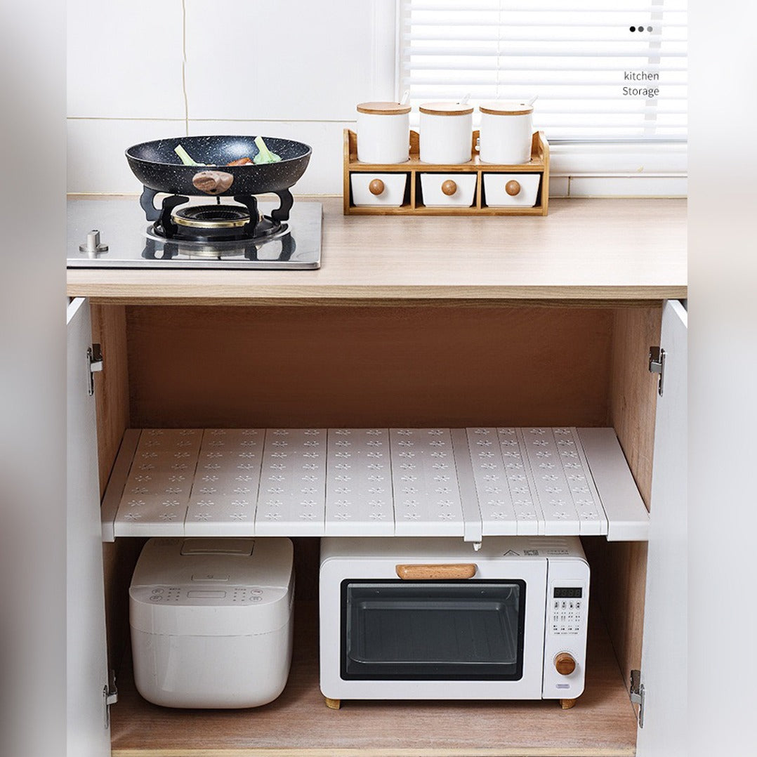 An Adjustable Cabinet Shelf Divider Organizer is Installed inside Kitchen Shelf.