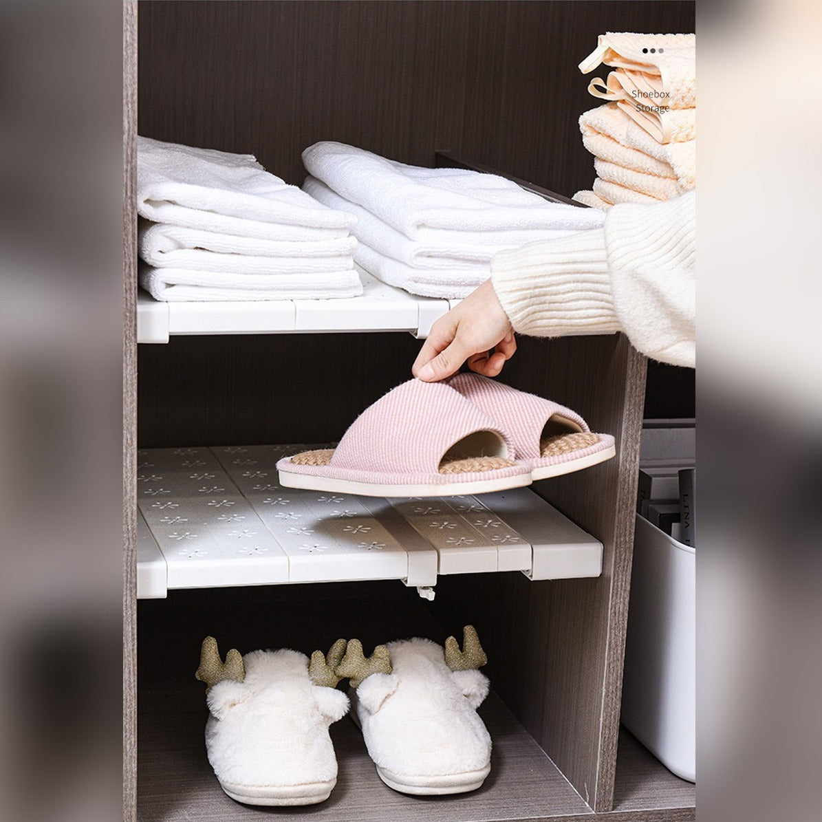 A Person is Keeping Her Belongings over djustable Cabinet Shelf Divider Organizer Installed inside a wardrobe.