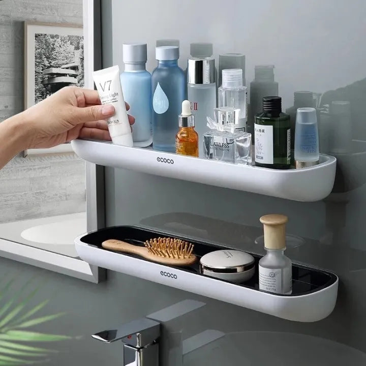 A wall-mounted bathroom storage rack with a shelf positioned above a wash basin, providing convenient storage space without the need for drilling