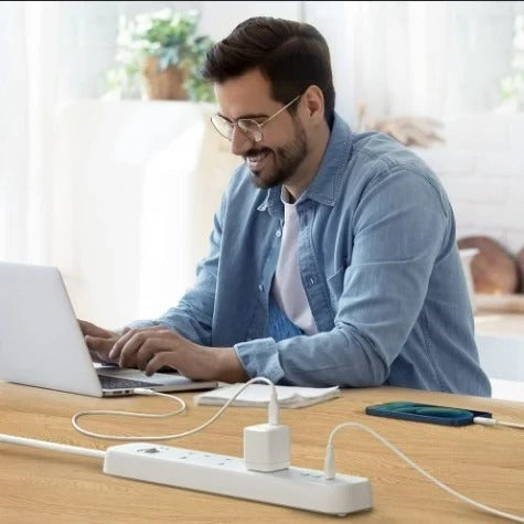 man using his laptop while its connevted to charge in Power Extended 3 USB‐C Strip