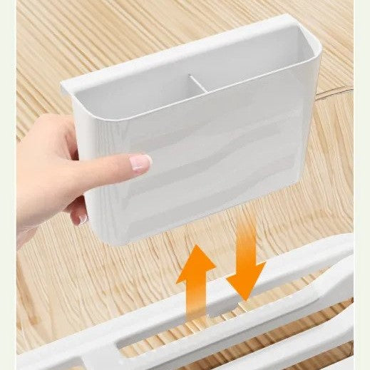 Someone taking one of the parts from Kitchen Sink Dish Storage Drain Rack