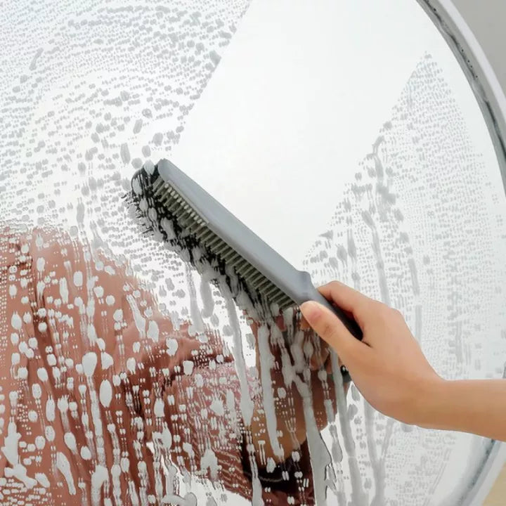 Someone is cleaning glass with the help of a 3-in-1 Multifunctional Cleaning Brush