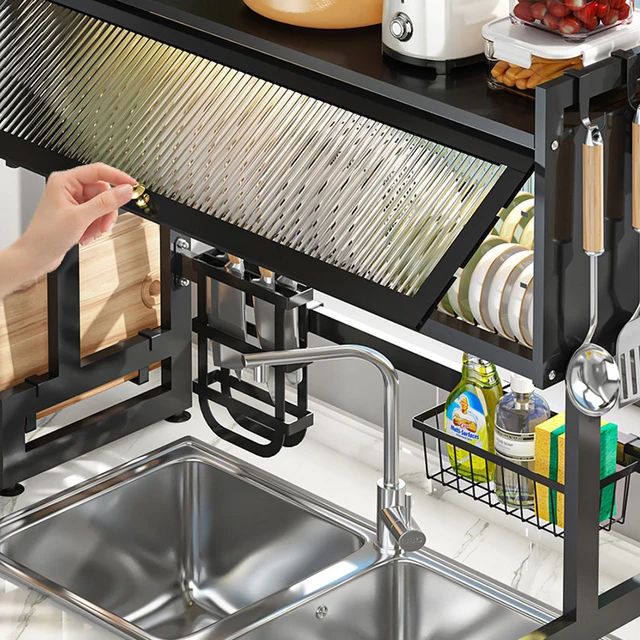 a lady opening the glass door of sink dish rack