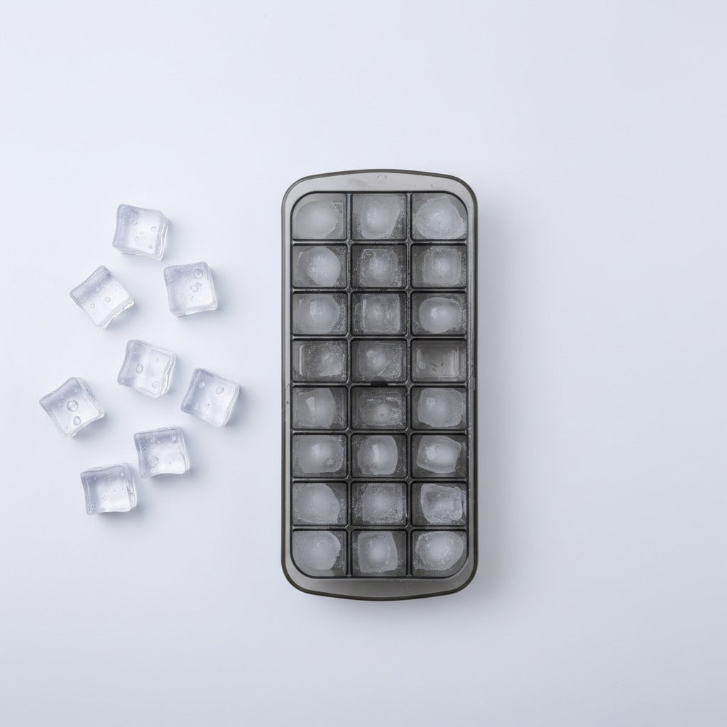 Ice cube tray with frozen ice cubes on a light gray background