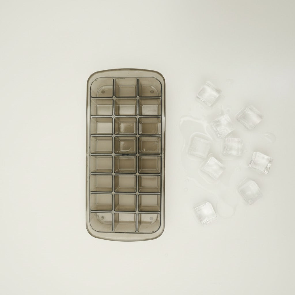 Ice cube tray with clear ice cubes on a light gray background