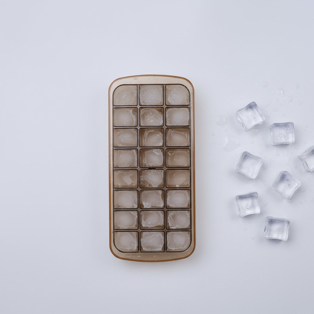 Ice cube tray with frozen cubes on a light gray background