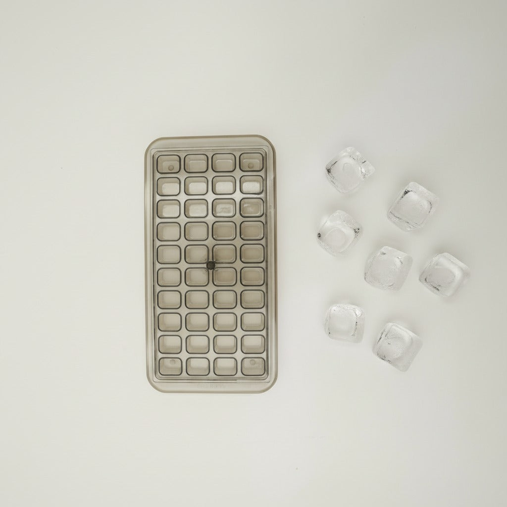 Rectangular ice cube tray with clear silicone ice cubes on a light gray background