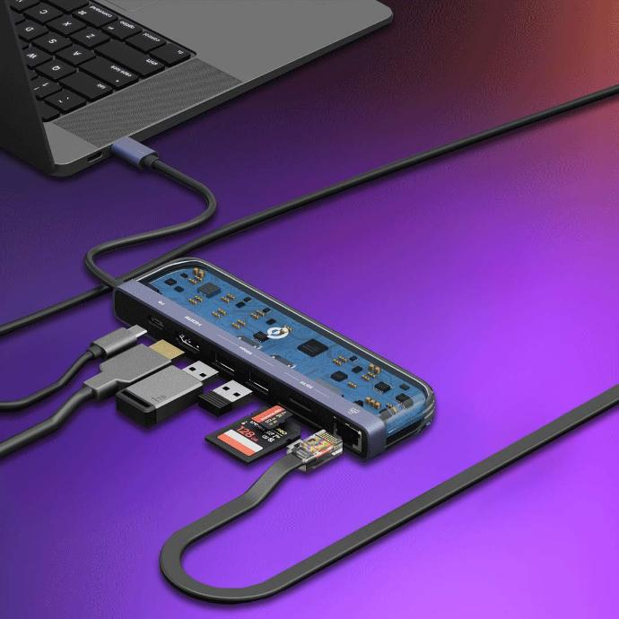 Powerology Universal 7-in-1 USB-C Multi Hub Crystalline Series placed on the table next to a laptop, which is plugged into it