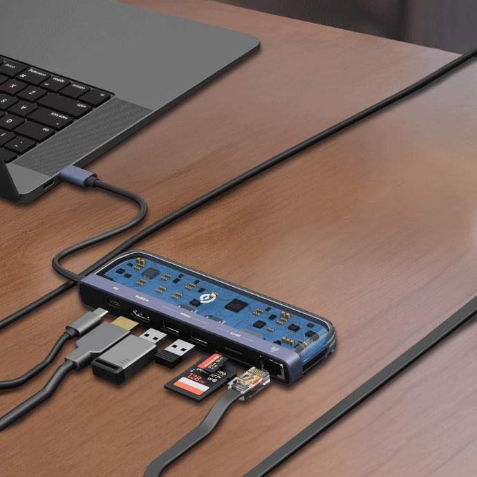 Powerology Universal 7-in-1 USB-C Multi Hub Crystalline Series placed on the table next to a laptop, which is plugged into it