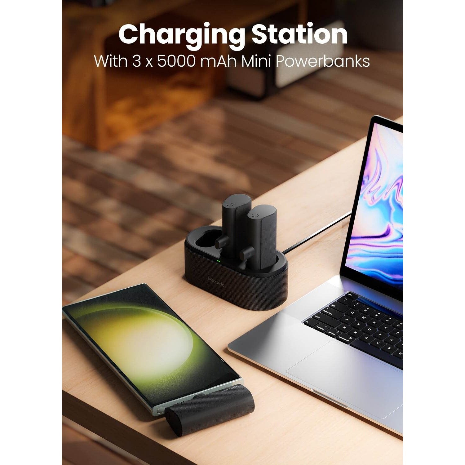 mini charging sation is Moxedo 3 in 1 3x 5000 mAh USB‐C Connector Power Bank. mobile is connected in the powerbank and beside theres a laptop