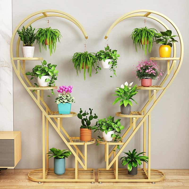 multi-tier plant stand with curved spiral design, featuring multiple shelves and hanging hooks displaying indoor potted plants and hanging planters.