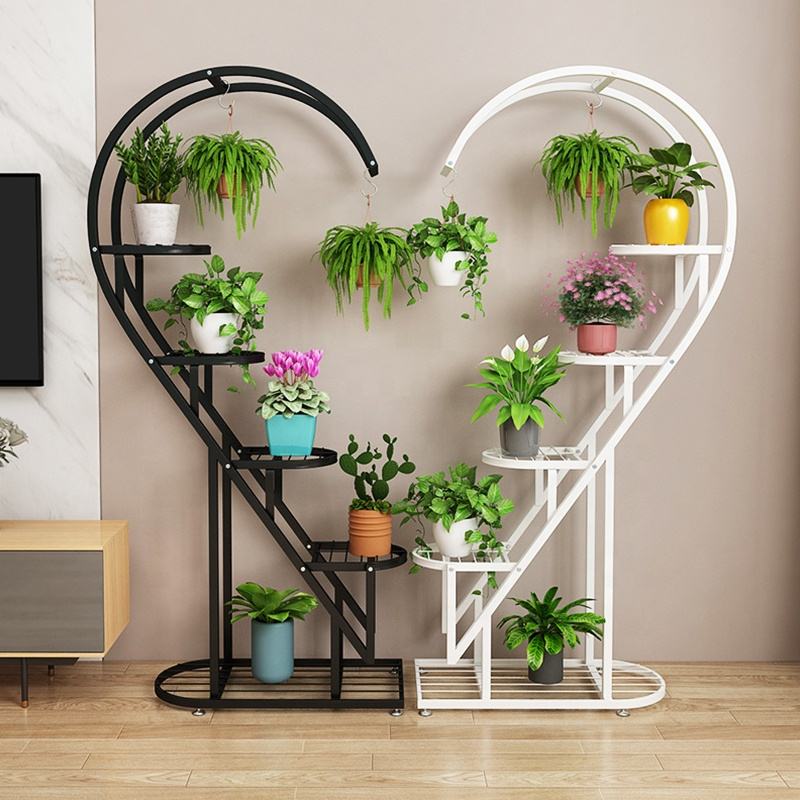 multi-tier plant stand with curved spiral design, featuring multiple shelves and hanging hooks displaying indoor potted plants and hanging planters.