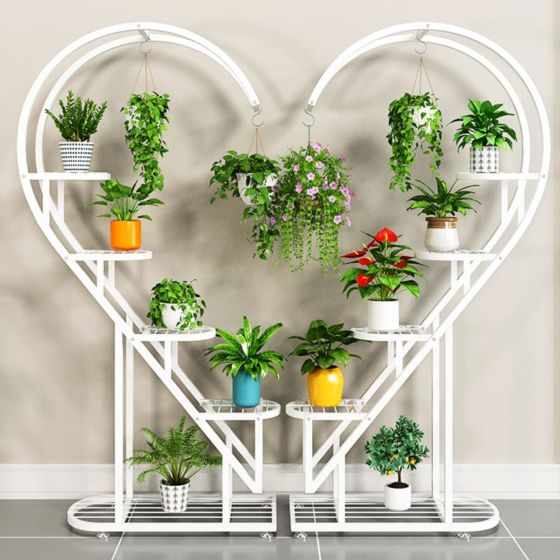 multi-tier plant stand with curved spiral design, featuring multiple shelves and hanging hooks displaying indoor potted plants and hanging planters.