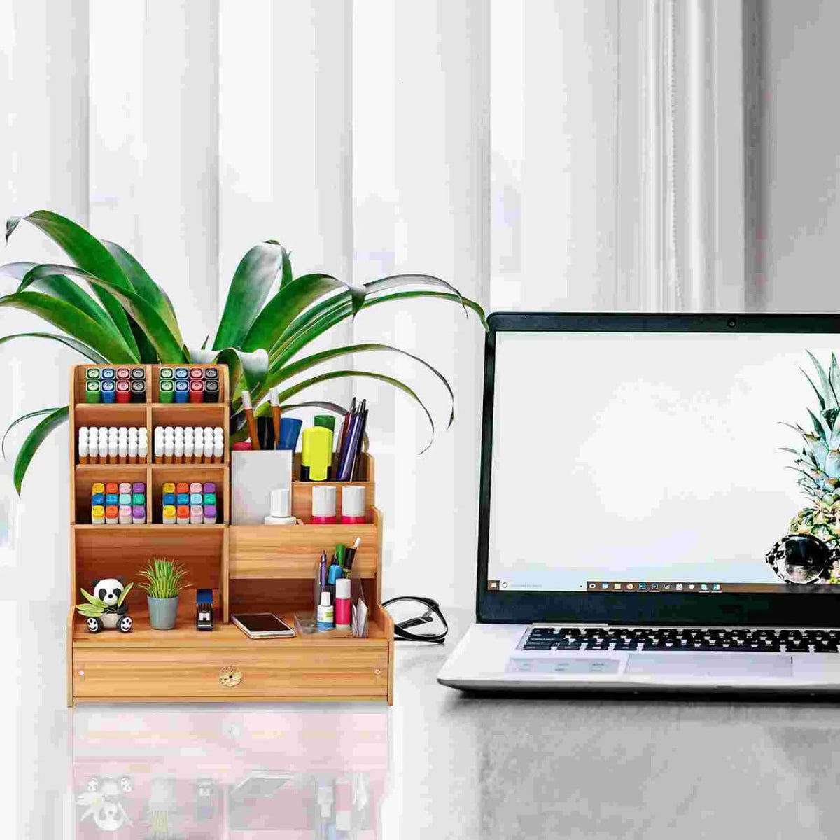 A Wooden Stand Organizer is Kept Beside on the Laptop.