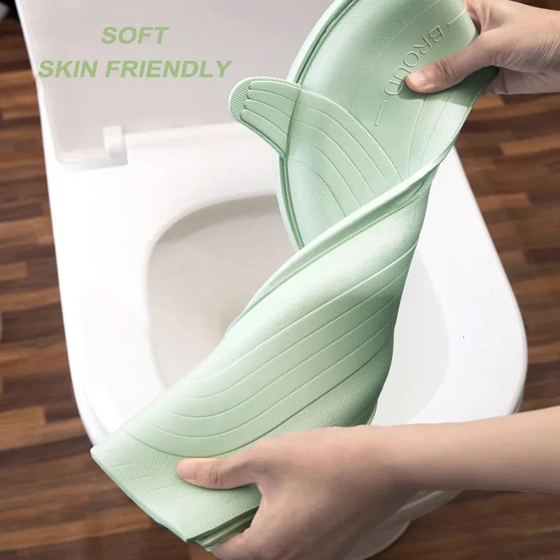 A person is demonstrating the soft feature of a padded toilet seat cover.