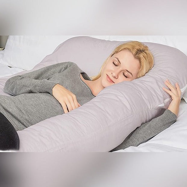 Mom-to-be cuddling with pregnancy pillow