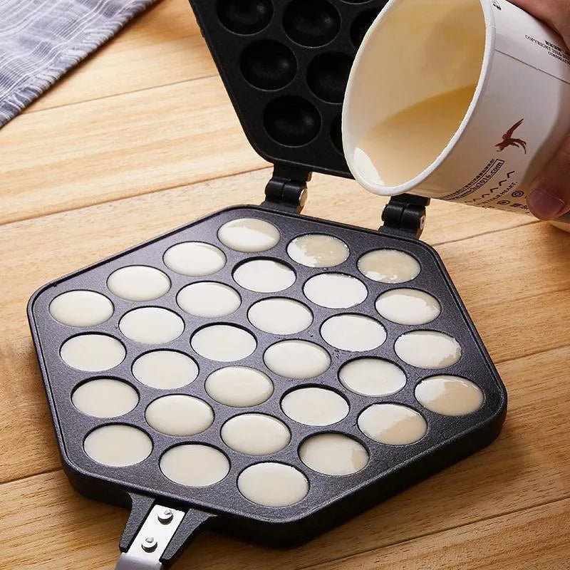 Someone pouring a recipe into the Non-stick Egg Puffs Maker Pan with some items