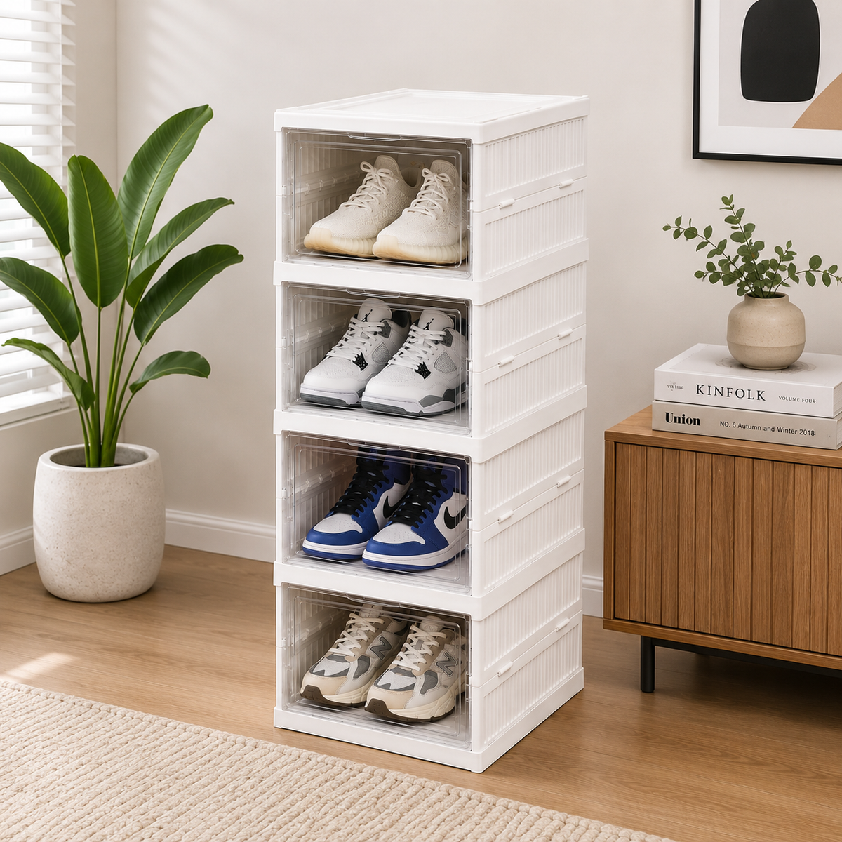 White shoe storage rack with shoes inside, placed in a room with a plant and books on a cabinet.