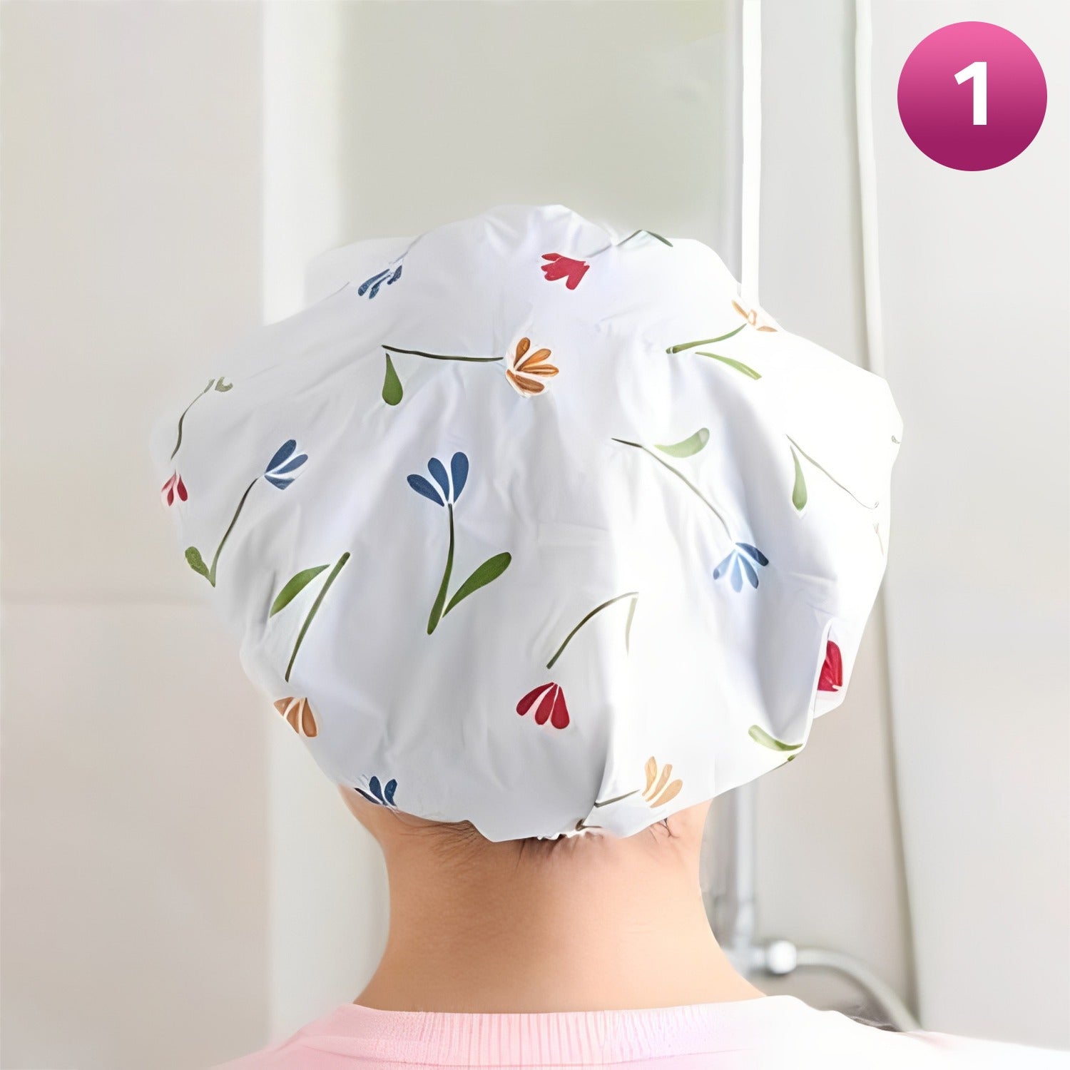 Person wearing a floral-patterned shower cap against a white background