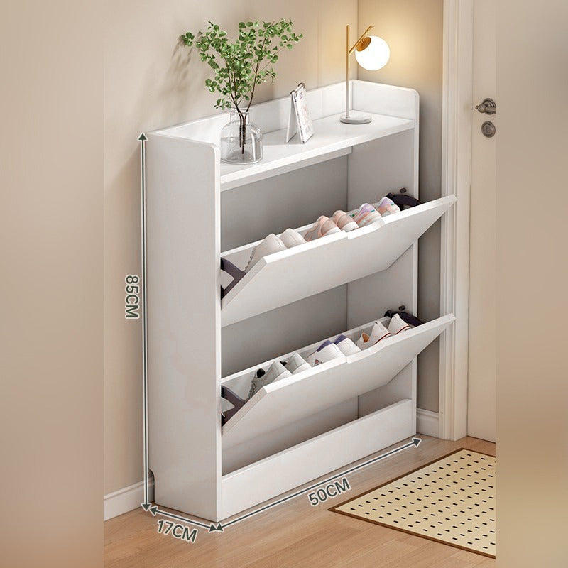 A slim shoe cabinet with flip drawers that neatly stores shoes while saving space, with a top surface for décor or essentials.