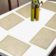 Set of table placemats on a white table with decorative vases.