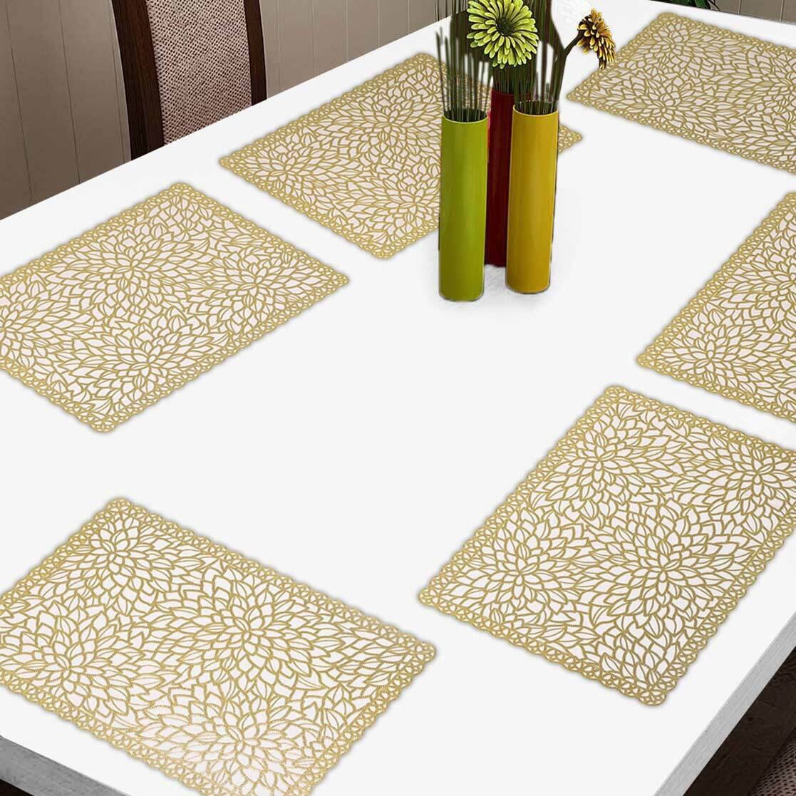 Set of table placemats on a white table with decorative vases.