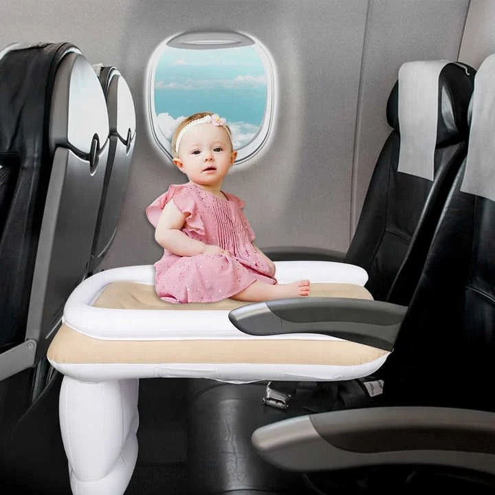 baby girl enjoying her plane in air bed
