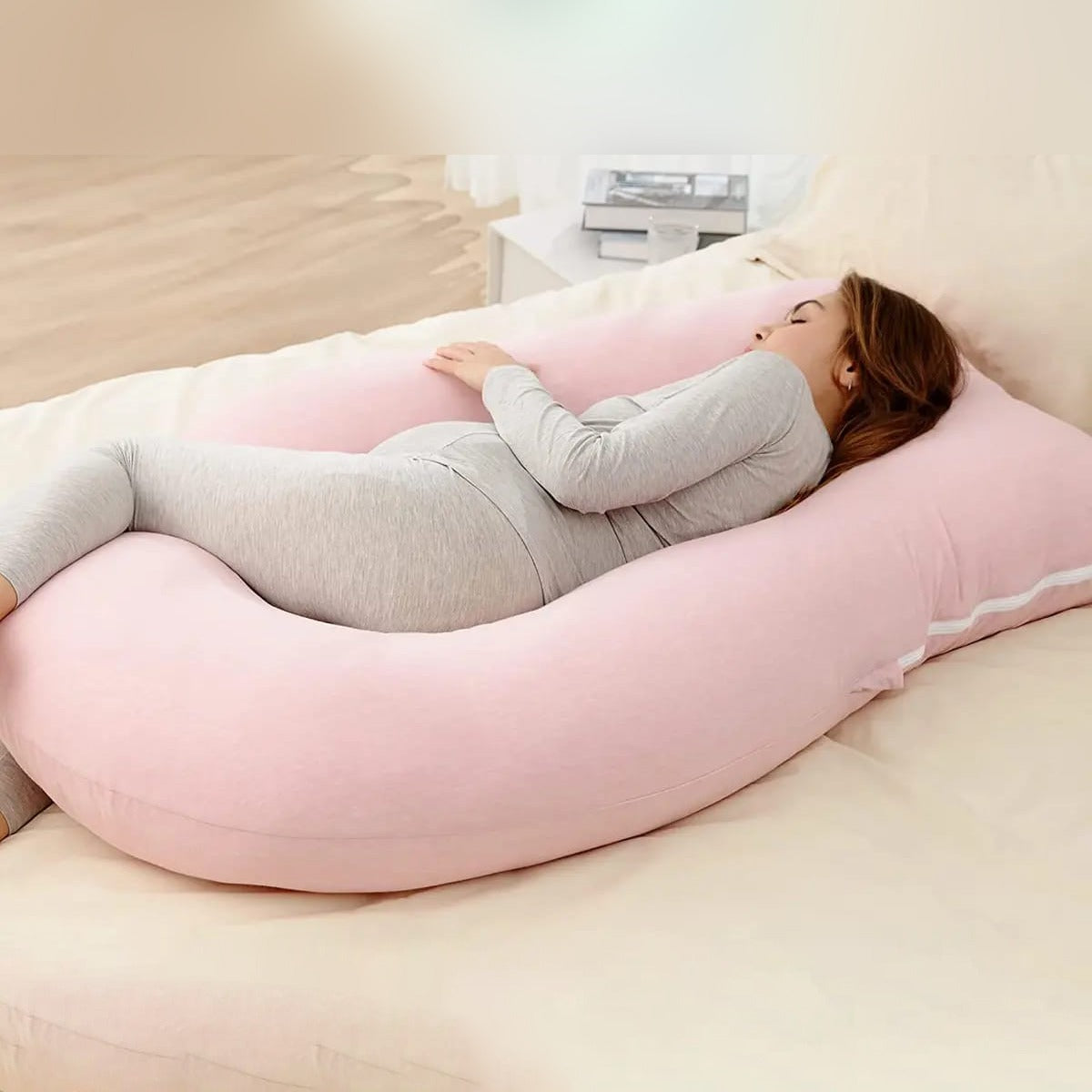 Pregnant lady using pregnancy pillow