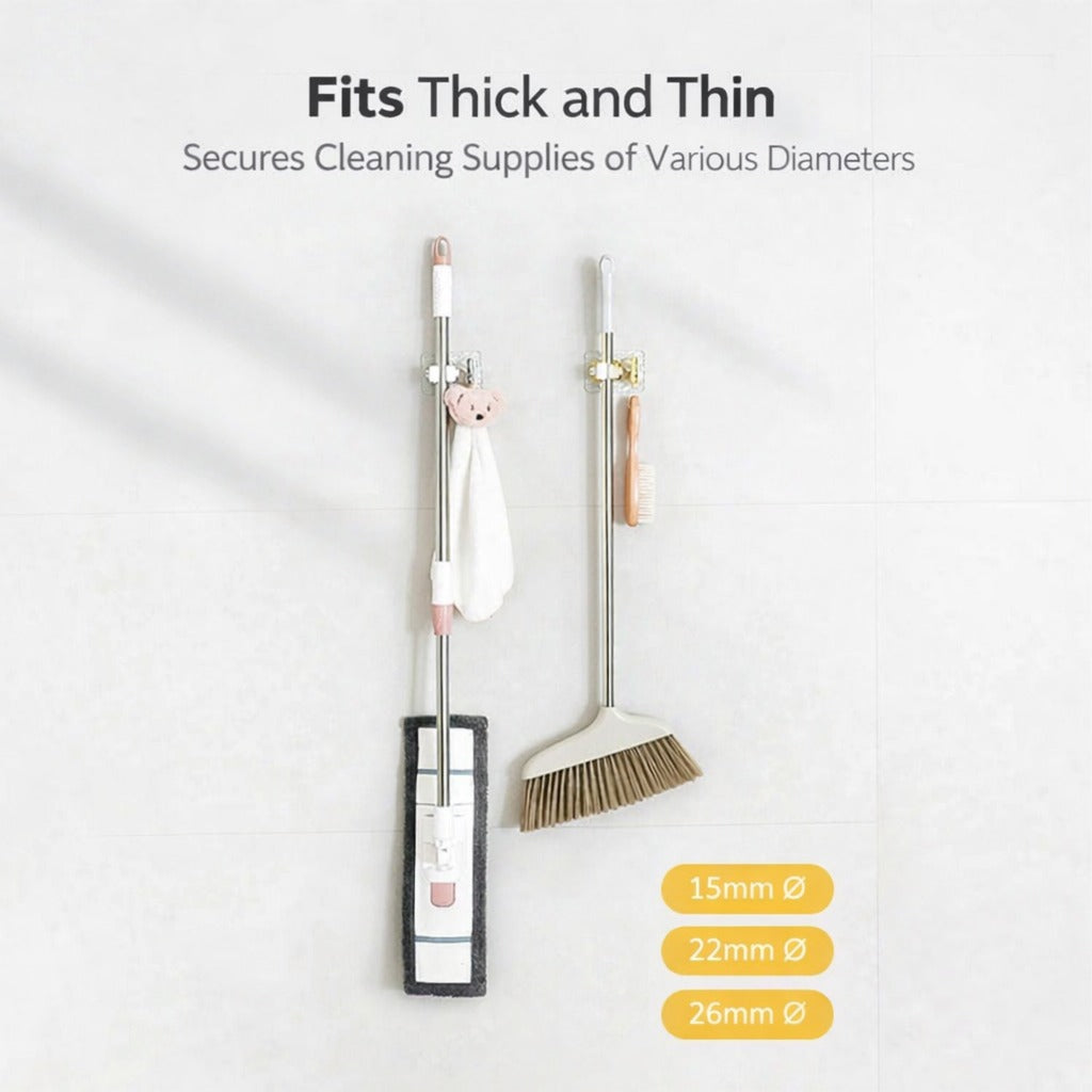 A set of wall-mounted mop and broom holders neatly organizing cleaning tools, featuring strong adhesive mounts and clips to keep items securely in place and save floor space.