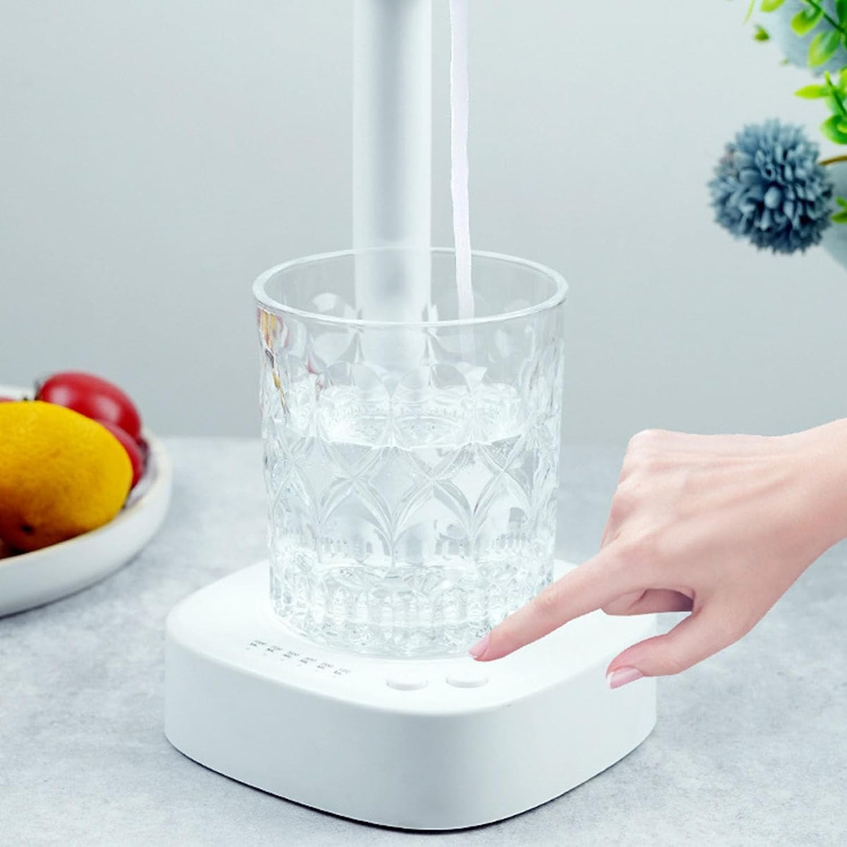 a lady going to click the button of desktop water pump 